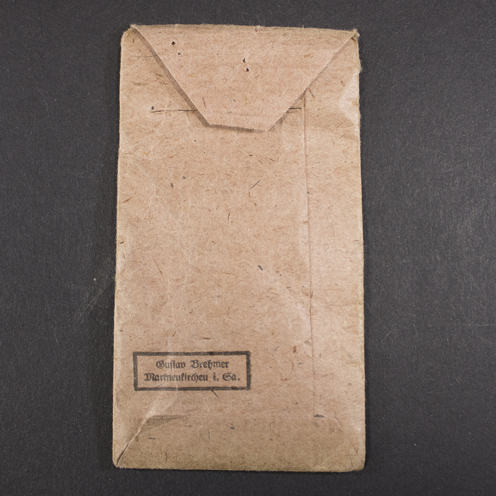 Reverse view of the original Eastern Front Medal packet, displaying the maker information and authentic age-related wear.
