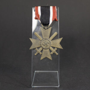 Original War Merit Cross with Swords, maker marked “64,” showing the complete decoration with ribbon and well-preserved wartime finish.