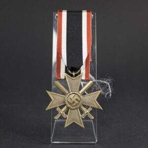 Original War Merit Cross with Swords showing the complete decoration with ribbon, featuring authentic wartime construction and finish.