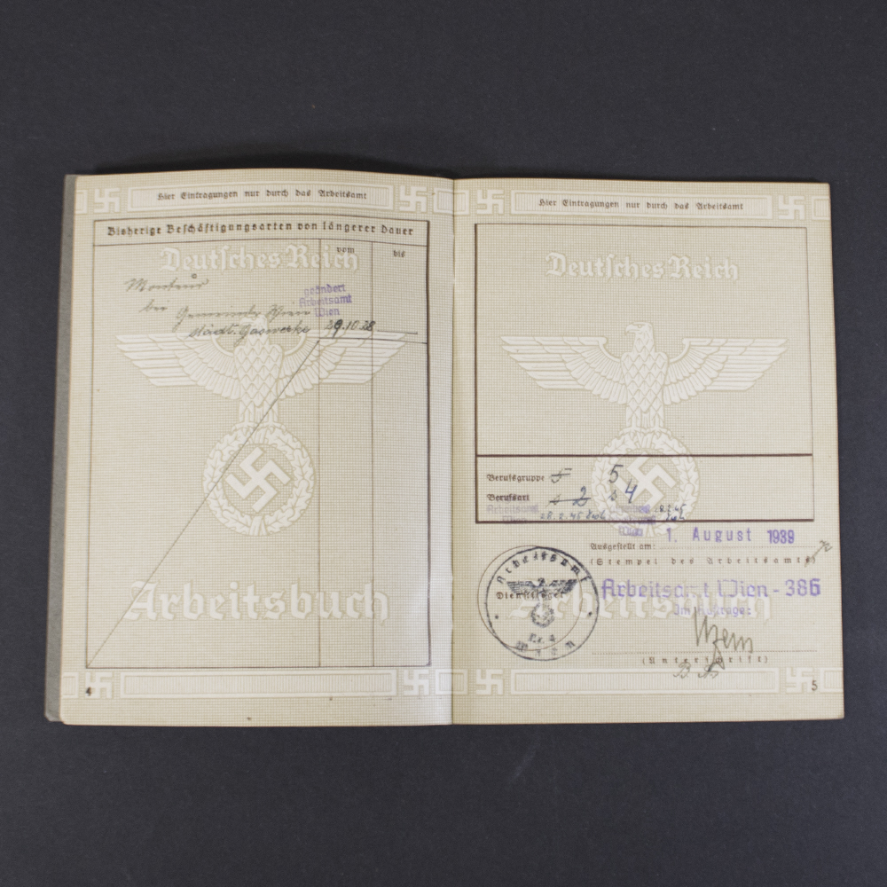 Inside page of a German World War II labor book showing employment records, workplace entries, handwritten notes, and official markings.