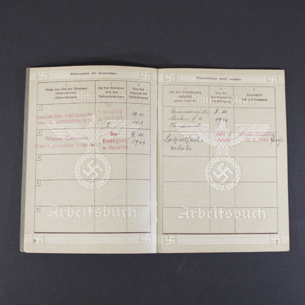 Interior page of a German WWII labor book containing additional employment history, administrative entries, stamps, and signatures.