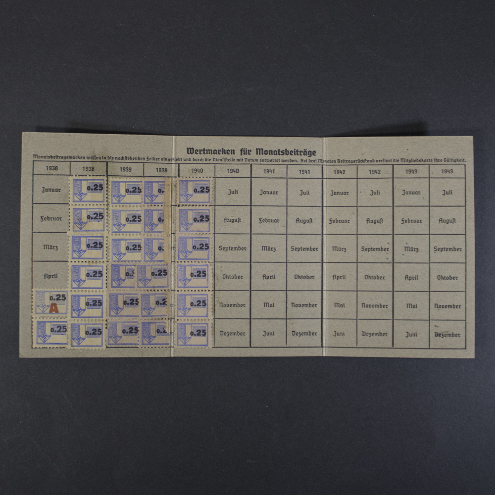 Opened Reichskolonialbund membership card displaying monthly contribution stamps from 1938 to 1940, with multiple 0.25 Reichsmark membership stamps affixed to the record grid.