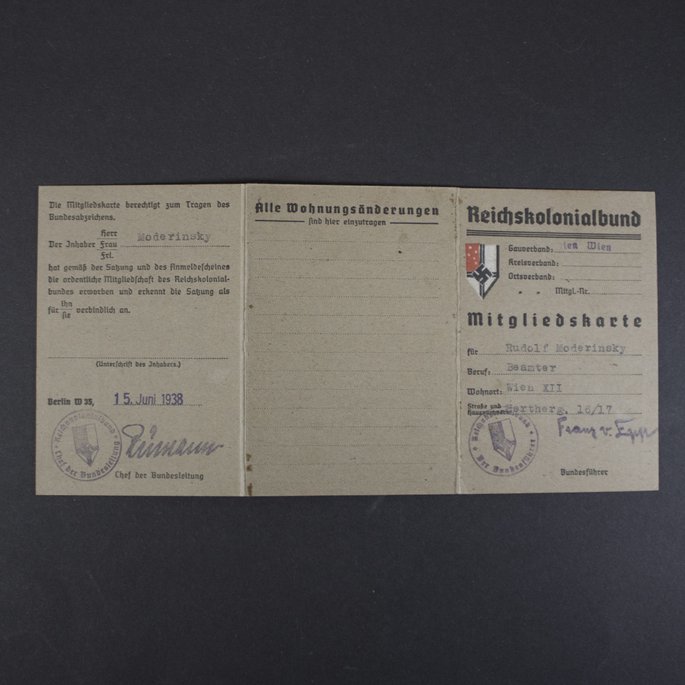 Interior of a Reichskolonialbund membership card showing the membership certification page, residential change section, official stamps, signatures, and member information.