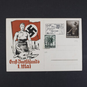 Color German WWII-era postcard titled “Groß-Deutschlands 1. Mai,” featuring an illustrated industrial worker holding tools in front of a red flag with a swastika emblem. The right side displays printed postage illustrations, including a portrait stamp and a May Day themed stamp design, along with address lines.