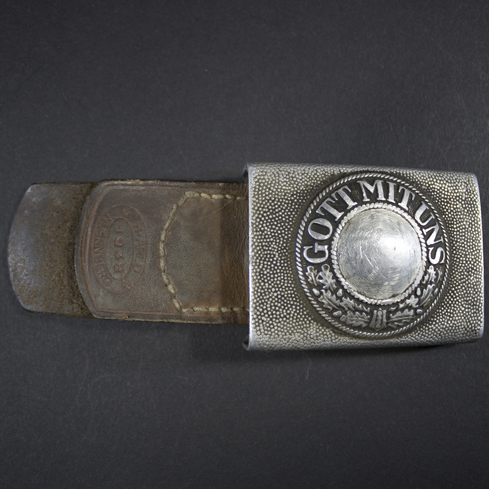 Front view of a WW2 German Heer army belt buckle with attached leather tab stamped H. Arld Nürnberg 1938.