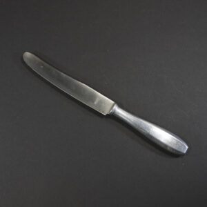 WW2 Wehrmacht dinner knife with aluminum handle and Rostfrei steel blade on a dark background.