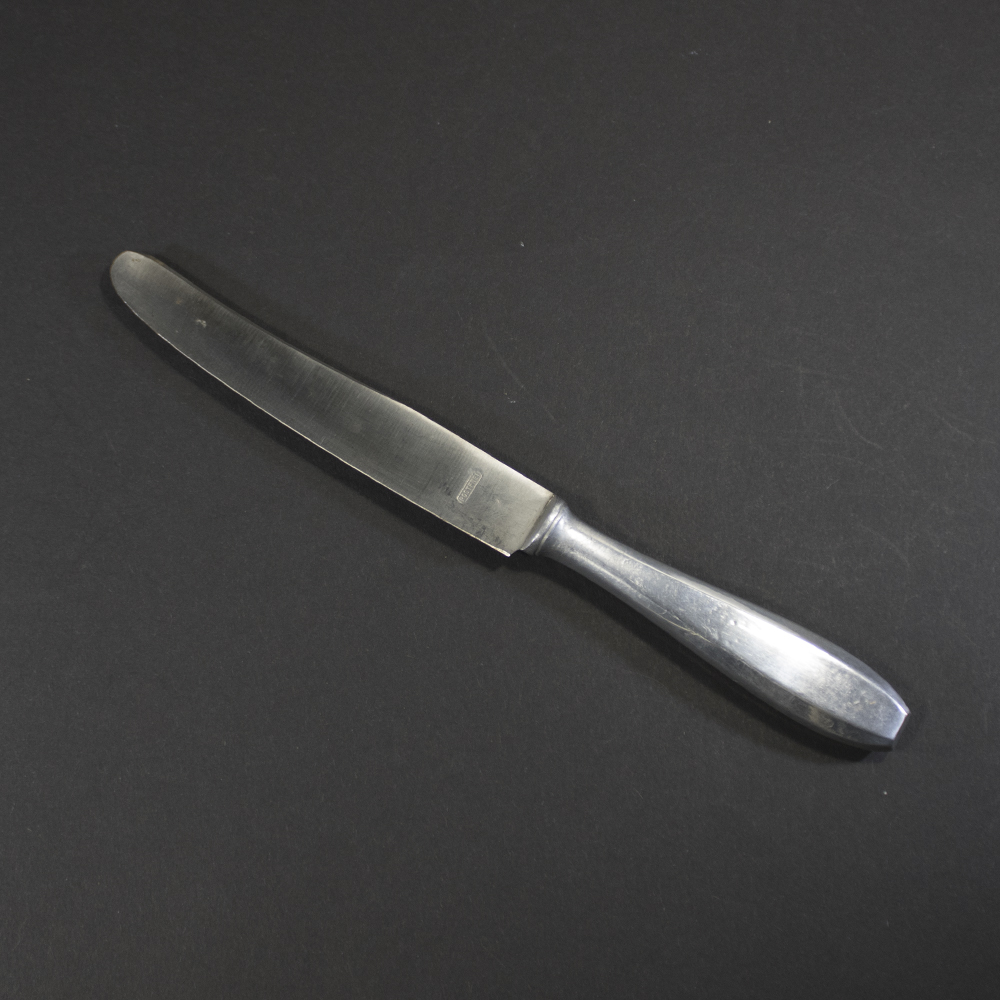 WW2 Wehrmacht dinner knife with aluminum handle and Rostfrei steel blade on a dark background.