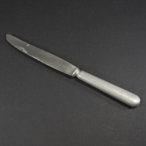 WW2 Wehrmacht canteen knife with aluminum handle and Solingen stainless steel blade on a dark background.
