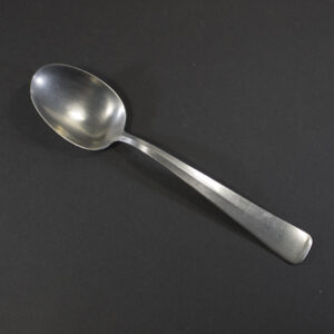 WW2 German Beauty of Labour stainless steel canteen spoon on a dark background.