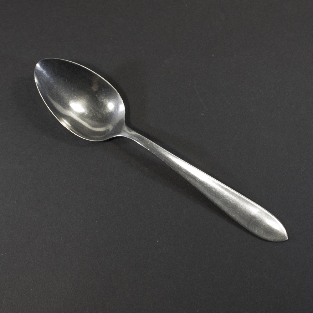 Front view of a WW2 German Wehrmacht Army stainless steel canteen spoon on a dark background.
