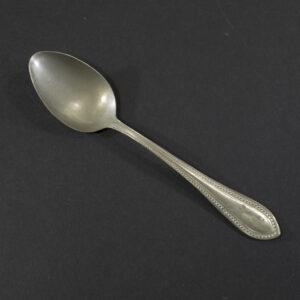 Front view of a WW2 German Kriegsmarine Alpaca dessert spoon showing the beaded handle border and property eagle.