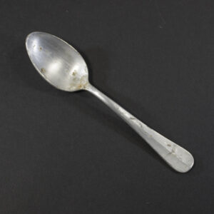 WW2 German Luftwaffe aluminum dessert spoon on a dark background showing the property eagle mark.