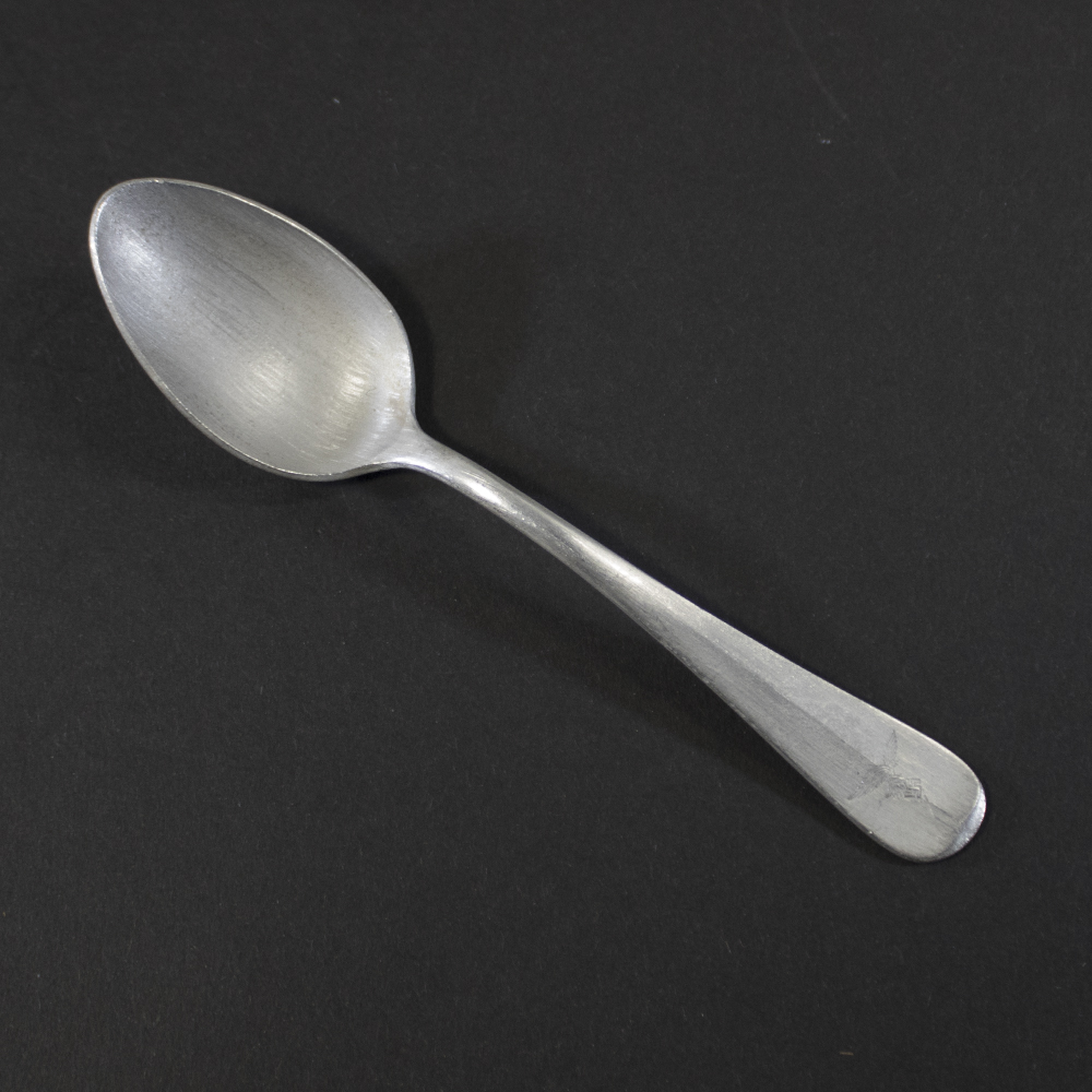 WW2 German Luftwaffe aluminum canteen dessert spoon on a dark background showing the property eagle mark.